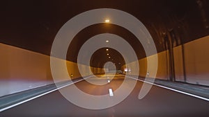 Timelapse of a speedy night drive trip through the Madeira tunnels. View from the car windshield to the road. Hyperlapse