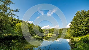 Timelapse summer landscape on mountains lake, Blue sky and clouds in Tuscany. Italy. Vibrant color