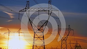 Timelapse: sun setting behind high voltage power transmission towers