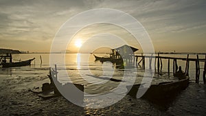 Timelapse Sunrise Dove Jetty with broken boat and wooden fisherman house