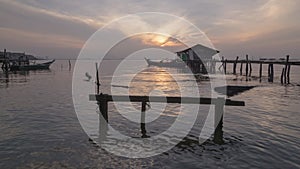 Timelapse Sunrise wooden bridge and abandoned boat