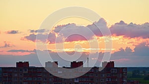 Timelapse of sunset over Siauliai city old soviet type buildings with few clouds