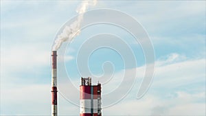 timelapse video of smoke from a factory pipe against a blue sky. Pollution of the environment.