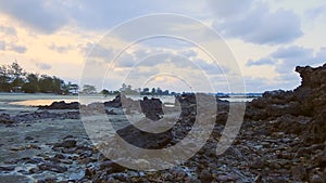 Timelapse view of peaceful beach with unidentified people during sunset