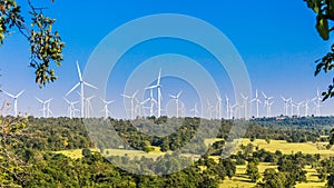 Timelapse of Wind turbine farm in beautiful nature with blue sky blackground, generating electricity