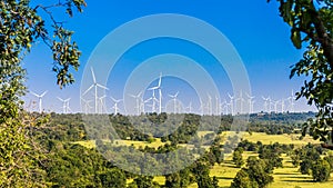 Timelapse of wind turbine farm in beautiful nature with blue sky blackground, generating electricity