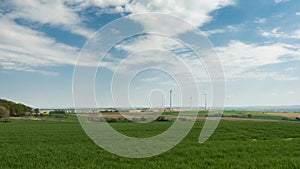 Timelapse - Wind Turbines under a partly cloudy sky