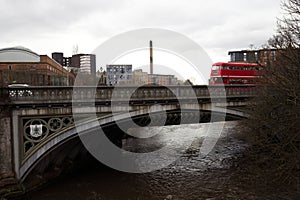 Timeless Journey: Vintage UK Bus Crossing a Glasgow Bridge