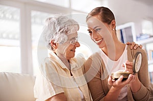 Timeless memories. a senior woman giving her daughter a pearl necklace.