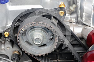 Timing belt and camshaft sprocket in car engine. photo