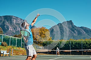 Timing is everything in this sport. a young male tennis player getting ready to serve the ball on a tennis court