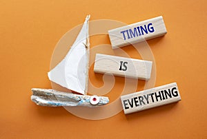 Timing is Everything symbol. Wooden blocks with words Timing is Everything. Beautiful orange background with boat. Business and