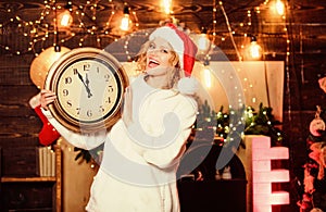 timing. happy new year. christmas preparation. girl in red santa claus hat. Midnight. Cheerful woman.. Time to celebrate