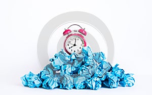 Timing and thinking idea with paper crumpled ball and red clock