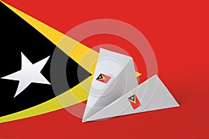 Timor Leste flag depicted on paper origami airplane. Handmade arts concept photo