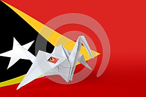 Timor Leste flag depicted on paper origami crane wing. Handmade arts concept photo