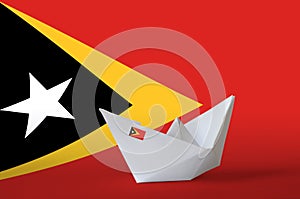 Timor Leste flag depicted on paper origami ship closeup. Handmade arts concept photo