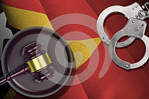 Timor Leste flag with judge mallet and handcuffs in dark room. Concept of criminal and punishment, background for photo