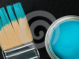 Tin of Blue Paint With a Paint Brush