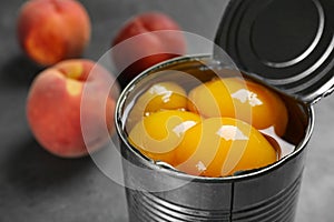 Tin can with conserved peach halves