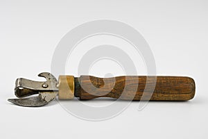 Tin can opener with wooden handle, isolated on white background.