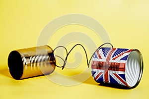 Tin can phone with British flag.communication concept