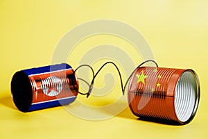 Tin can phone with China and North Korea Flag .communication concept