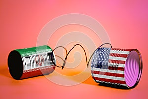 Tin can phone with USA and Iran Flags.communication concept