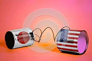 Tin can phone with USA and Japan Flags.communication concept