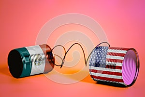 Tin can phone with USA and Mexico Flags.communication concept