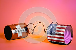 Tin can phone with USA and Swiss Flags.communication concept