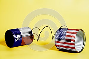 Tin can phone with USA and Texas U.S. state Flags. communication concept