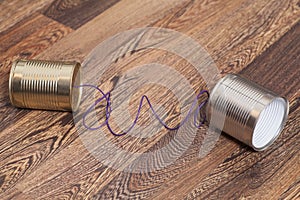 Tin Can Phone on Wooden Background