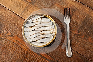 Tin can of sardines on rustic backgeound. Top view