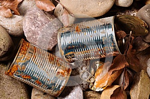 Tin can waste on pebble beach floor closeup