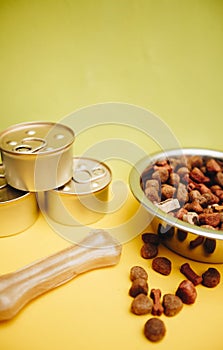Tin cans and a bowl with pet food