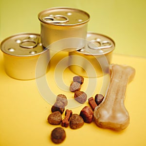 Tin cans of pet food and a snack for dogs