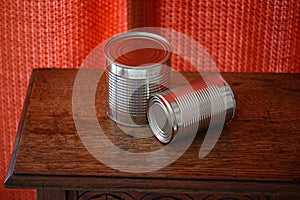 Two empty tin cans on a table.