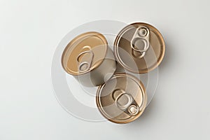 Tin cans with wet cat food on white background, top view