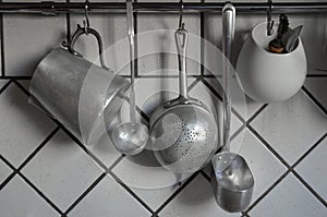 Tin coocking utensils hanging in kitchen