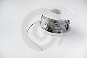 Tin-lead solder in coils on a white background. Materials for soldering