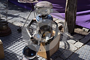 Tin man playing the saxaphone on the street