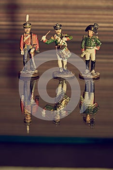 Tin soldiers stand on the glass surface