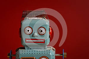 Tin toy robot against red background