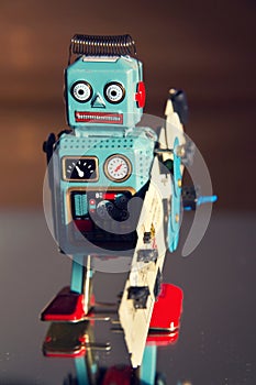 Tin toy robot carries computer circuit board, artificial intelligence concept