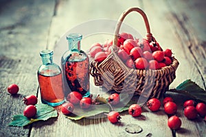 Tincture bottles of hawthorn berries and ripe thorn apples