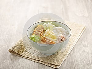 Ting Zai Style Congee served in a dish isolated on mat side view on grey background