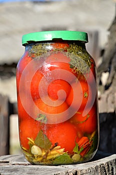 Tinned tomatoes in a jar with a lid.