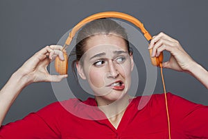 Tinnitus headphones concept for dubious 20s girl photo