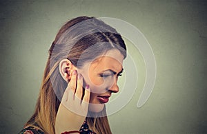 Tinnitus. sick young woman having ear pain touching her painful head